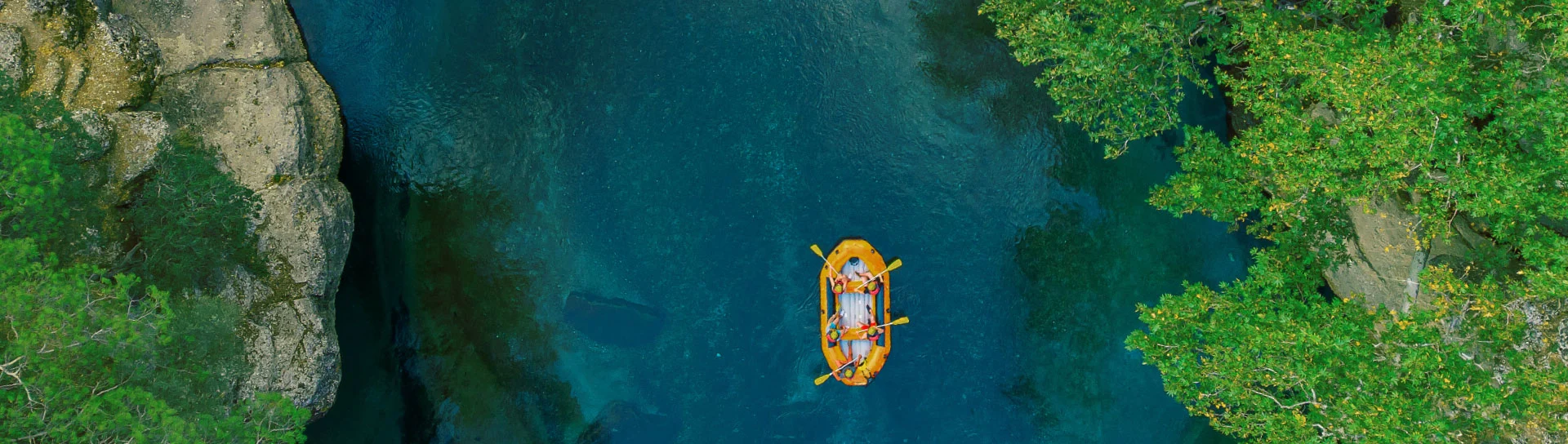 An image of water, a river with a rubber dinghy
